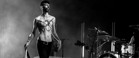 A handout picture released by Morocco's Mawazine Festival on June 2, 2015, shows Stefan Olsdal, guitarist-bassist of the alternative British rock band Placebo, walking on stage with the number 489 written on his chest, in reference to article 489 which stipulates that homosexuality is punishable in Morocco by up to three years in jail, during the 14th edition of the music festival in Rabat. Placebo used their appearance at a Moroccan music festival to protest the kingdom's gay rights record in a performance that saw a band member play a rainbow-coloured guitar. AFP PHOTO / HO / SIFE EL AMINE == RESTRICTED TO EDITORIAL USE - MANDATORY CREDIT "AFP PHOTO / HO / SIFE EL AMINE" - NO MARKETING NO ADVERTISING CAMPAIGNS - DISTRIBUTED AS A SERVICE TO CLIENTS ==