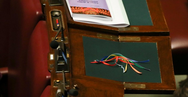 Lazos de colores sobre uno de los escritorios antes de la votación final de las uniones civiles entre homosexuales en la cámara baja del Parlamento de Italia en Roma